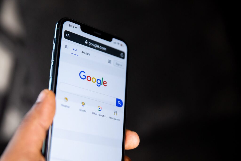 Person holding a phone which shows Google Business Manager